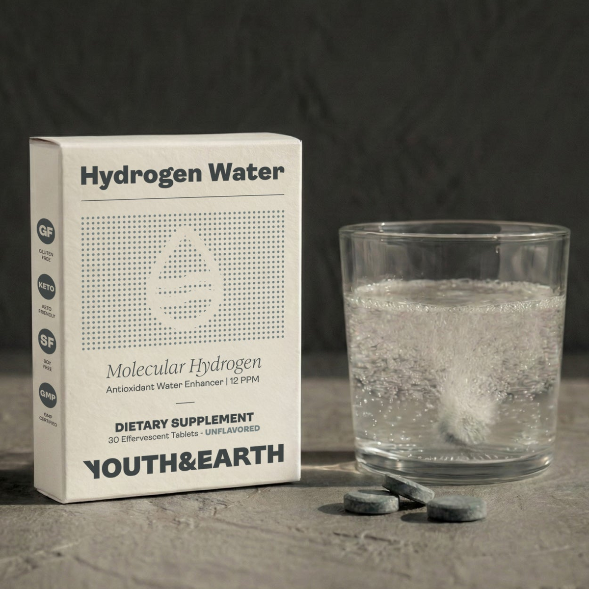 Hydrogen Tabs in white packaging and grey tablets bubbling in water