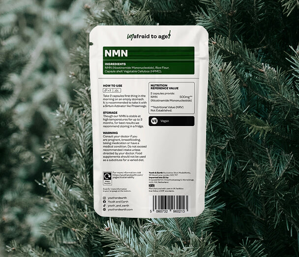 Supplement package labeled 'NMN' on a green leafy background