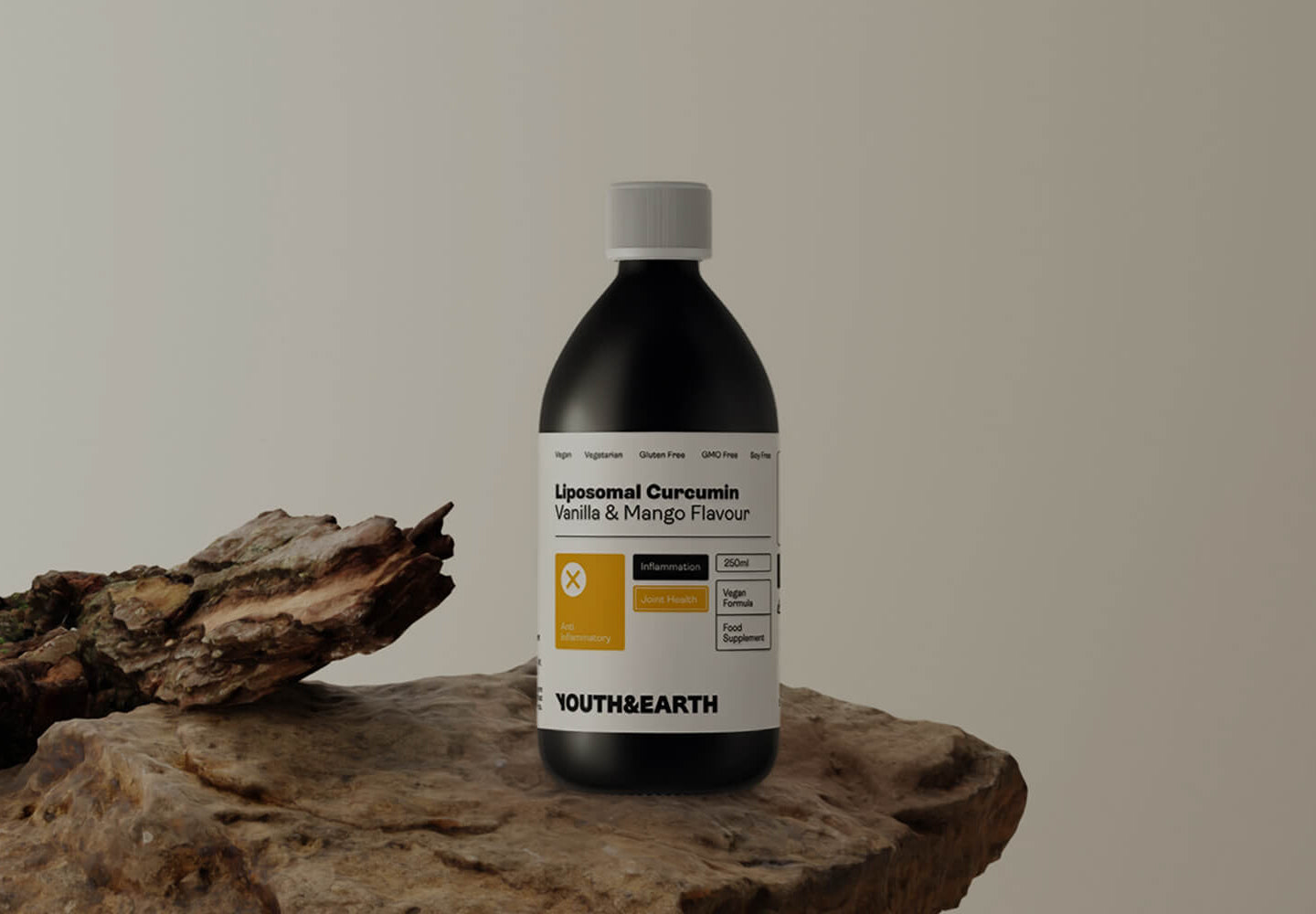Bottle of Lipoosomal Curcumin Vanilla & Mango Flavour on a stone surface with a neutral background