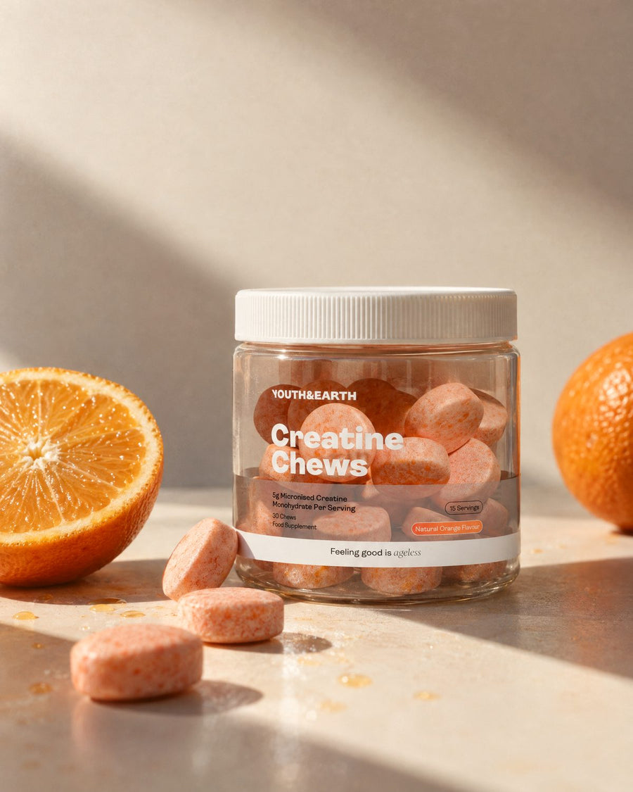 A tilted jar of Creatine Chews with chews scattered across a warm surface